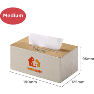 A medium tissue box with a beige fabric cover and a wooden top, featuring a logo on the side.