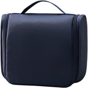 A hanging travel toiletry bag in navy blue with a zip closure and a sturdy handle on top.