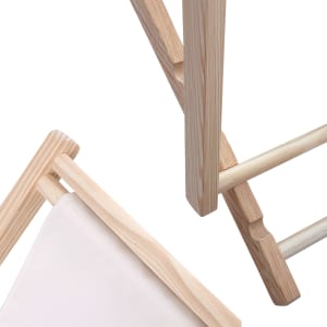 A wooden beach chair featuring light timber framing and a fabric seat. The image captures close-up details of its structure.