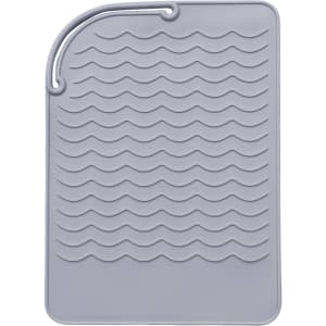 A grey silicone pad with a wavy texture, designed for heat protection. It features a small loop for hanging.