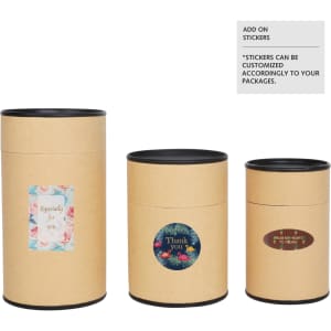 Large kraft paper cylinders with black lids, featuring decorative stickers in various designs and sizes.