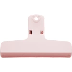 A pink plastic clip with a hanging hole. The design is simple and functional, suitable for various uses.