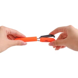 A pair of multifunctional scissors in orange, being held by two hands, showcasing a compact design.
