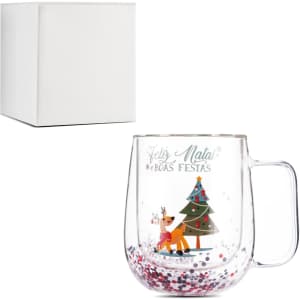 A transparent glass mug with a festive design, featuring a Christmas tree and colourful glitter. Includes a white box.