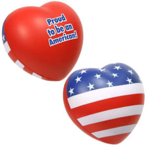A large heart-shaped stress reliever in red with a blue and white star-patterned design, featuring a logo.