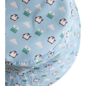 A blue bucket hat featuring a pattern of penguins and houses, with a logo on the side.