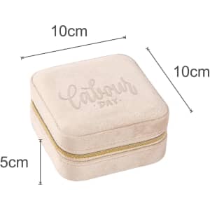 A velvet jewellery organiser in ivory, measuring 10cm x 10cm x 5cm, with a zip closure and a subtle logo.