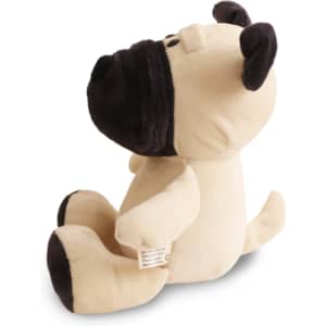 A beige and black dog plush toy sits upright, featuring a friendly expression and soft texture.