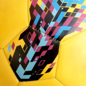 A yellow soccer ball featuring a vibrant geometric pattern in blue, pink, and black, with a logo present.
