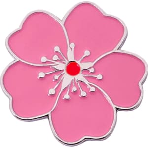 A pink soft enamel golf ball marker shaped like a flower, featuring a red centre and silver outline.