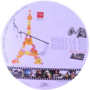 A round mouse mat featuring a floral design and the Eiffel Tower. It includes a logo and a film strip motif.