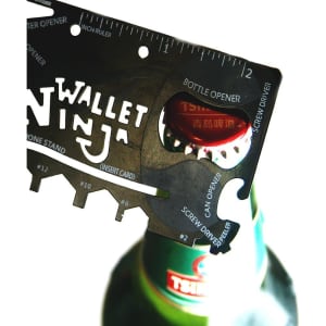 A card-sized multi-tool in black featuring a bottle opener, screw driver, and ruler, designed for compact convenience.