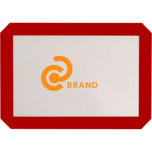A silicone baking mat with a red border and a logo in the centre. The mat is predominantly grey.