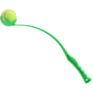 A green ball thrower with a curved arm and grip, featuring a yellow tennis-like ball at the end.