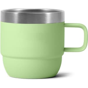 A stackable stainless steel mug in a pastel green shade with a silver rim and a sturdy handle.