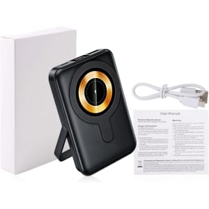 A black 10000mAh magnetic wireless power bank with a gold circle design and a built-in phone stand, accompanied by a charging cable and user manual.