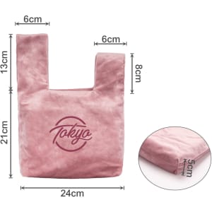 A pink velvet knot wrist bag with a logo, featuring a rectangular body and dual handles. Dimensions included.