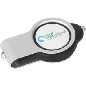 A silver and black light-up flash drive with a round, branded surface.