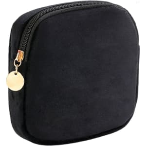 A stylish mini makeup bag in black suede, featuring a gold zipper and pull tab.