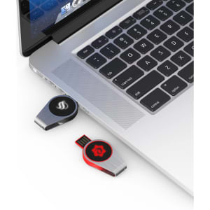 A swivel lighting logo flash drive in black and red connected to a laptop. It features a sleek metallic design.