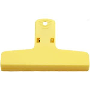A yellow plastic magnetic clip with a flat design and a hole for hanging. It features a logo on the surface.