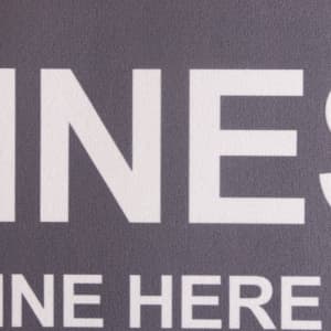 A grey floor mat featuring a logo and large text, designed for office or business environments.