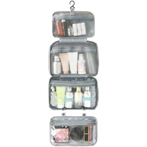 A large capacity hanging toiletry bag in grey, featuring multiple transparent compartments filled with various toiletries.
