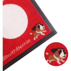 A red nylon logo mat features a playful dog design and a circular white area, with a black border around it.