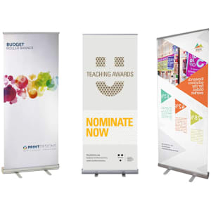 Three pull-up banners in various designs: a colourful abstract pattern, a teaching awards banner, and a geometric promotional banner.