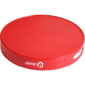 A round red serving tray with a textured surface and a side handle, featuring a logo.