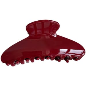 A deep red acetate hair clip with a curved design and multiple gripping teeth. It features a shiny finish and branding.