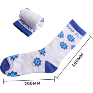 A pair of blue and white crew socks featuring a floral design, with one rolled up next to the other.