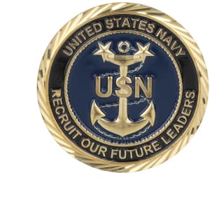 A gold and navy enamel commemorative coin pin featuring an anchor design and the text "United States Navy."