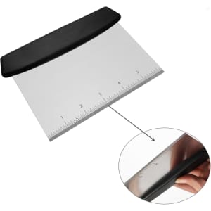 A bench scraper with a plastic black handle and a stainless steel blade featuring measurement markings.