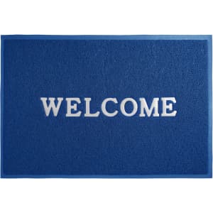 A blue floor mat with a textured surface featuring a welcome message in white lettering.