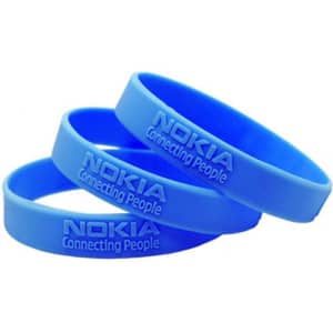 A set of three blue silicone wristbands featuring a logo and embossed text.