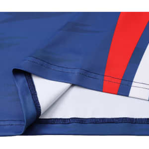 A close-up of a blue long-sleeved T-shirt featuring red and white stripes and a logo.