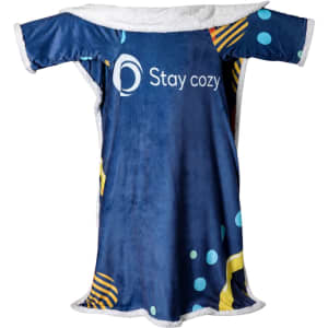A blue and patterned wearable blanket with a soft, white lining and a logo is displayed.
