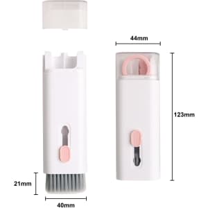 A compact white cleaning kit featuring a brush and a pink silicone attachment, with a protective cover.