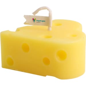 A yellow heart-shaped candle resembling a cheese wedge, featuring a small flag and holes throughout.