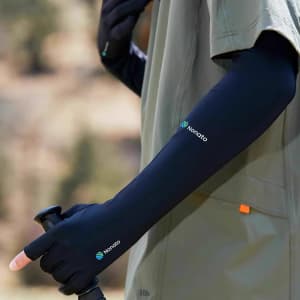 Long sleeve sun protective gloves in black with two open fingers, featuring a small logo on the arm.