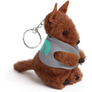 A brown plush kangaroo toy with a keychain, wearing a grey pouch. It has a small tail and black feet.