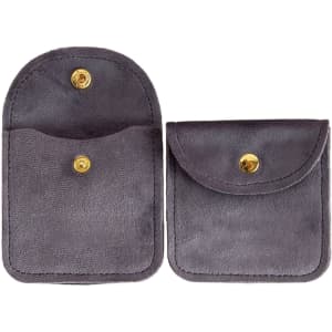 A grey velvet jewelry pouch with a snap closure and a small front pocket. It features a branding logo.