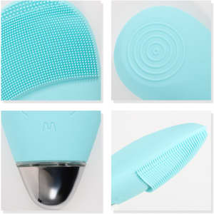 A silicone facial cleansing brush in light blue, featuring textured surfaces and a sleek metallic base.