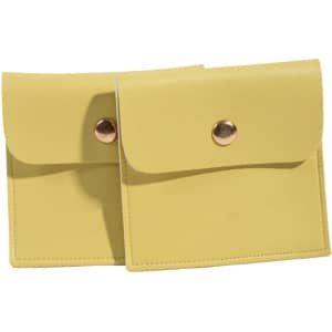 A pair of yellow PU leather jewelry pouches with snap closures, featuring a simple design and a logo.