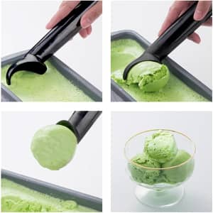 An ice cream scoop with a black handle is shown scooping green ice cream, forming a ball in a glass bowl.