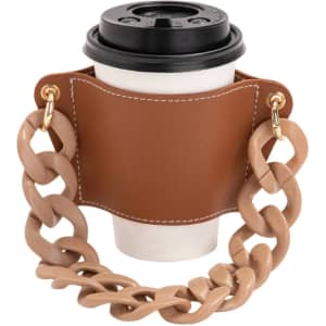A drink bottle holder in brown leather with a chunky acrylic strap, designed to carry a coffee cup securely.