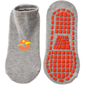 Low cut grey gripper socks featuring a textured orange bottom and a small logo.