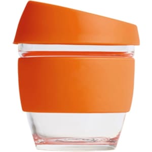 A reusable glass coffee cup with a transparent body and an orange silicone lid and sleeve.