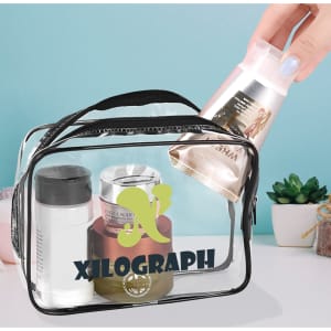 A clear toiletry bag with various cosmetic containers, including lotions and creams, on a blue background.